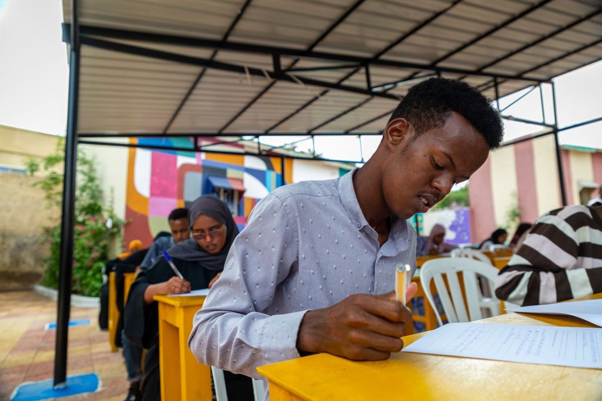 A participant writing in his notebook